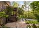 Wood stairs leading up to an entrance, surrounded by trees and landscaping, creating a tranquil approach at 195 Nicks W Bnd, Pittsboro, NC 27312
