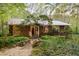 Charming home exterior with wood siding, metal roof, and beautifully landscaped front yard at 195 Nicks W Bnd, Pittsboro, NC 27312