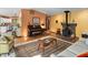 Spacious open-concept living room with fireplace, piano, and ample seating at 195 Nicks W Bnd, Pittsboro, NC 27312