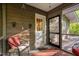 Cozy porch with wood paneling, a comfortable chair, and an entrance to the outside at 195 Nicks W Bnd, Pittsboro, NC 27312