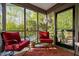 Cozy screened porch featuring comfortable seating, a rug, and views of the surrounding greenery at 195 Nicks W Bnd, Pittsboro, NC 27312