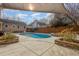 Private in-ground pool with a sunshade, surrounded by mature landscaping and a wooden fence at 2009 Mallard Ln, Raleigh, NC 27609