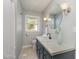 Updated bathroom featuring modern fixtures, a vanity, and a window for natural light at 2009 Mallard Ln, Raleigh, NC 27609