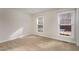 Neutral bedroom showcasing two windows offering bright natural light at 2009 Mallard Ln, Raleigh, NC 27609