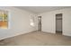 Bedroom featuring tan carpet, neutral walls, closet access, and natural light at 2009 Mallard Ln, Raleigh, NC 27609