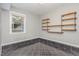 Bright bonus room with tile flooring, a window for natural light, and metal shelving at 2009 Mallard Ln, Raleigh, NC 27609