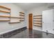 Versatile bonus room with tile flooring, wood shelving, and neutral-colored walls at 2009 Mallard Ln, Raleigh, NC 27609