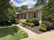 Beautiful landscaped front exterior of the home with manicured shrubs and walkway at 2009 Mallard Ln, Raleigh, NC 27609