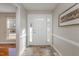 Welcoming foyer with a decorative tile floor, paneled walls, and a charming welcome sign at 2009 Mallard Ln, Raleigh, NC 27609