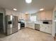 Bright kitchen featuring stainless steel appliances, white cabinets, and tile flooring at 2009 Mallard Ln, Raleigh, NC 27609