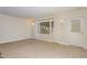 Bright living room with neutral walls, carpet flooring, and a glass-paneled door at 2009 Mallard Ln, Raleigh, NC 27609