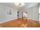 Bright, airy living room featuring gleaming hardwood floors, neutral walls, and an elegant light fixture at 2009 Mallard Ln, Raleigh, NC 27609