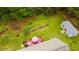 Spacious backyard featuring a deck with outdoor seating, garden plots, and storage building at 201 Lexington Park Dr, Oxford, NC 27565