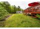 Expansive backyard with a shed and garden beds surrounded by lush greenery at 201 Lexington Park Dr, Oxford, NC 27565