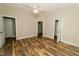 Spacious bedroom with multiple doorways, a ceiling fan, and faux wood floor at 201 Lexington Park Dr, Oxford, NC 27565