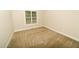 Neutral bedroom with tan carpet and a window at 201 Lexington Park Dr, Oxford, NC 27565