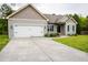 Charming single-Gathering home featuring a well-maintained lawn, an attached garage, and a long driveway at 201 Lexington Park Dr, Oxford, NC 27565