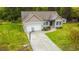 Well-maintained house featuring an attached garage, driveway with basketball hoop, and lush green lawn at 201 Lexington Park Dr, Oxford, NC 27565