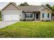 Charming single-Gathering home featuring a well-maintained lawn, an attached garage, and lovely landscaping at 201 Lexington Park Dr, Oxford, NC 27565