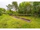 Backyard garden beds with young trees in a well-maintained grassy area at 201 Lexington Park Dr, Oxford, NC 27565