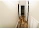Hallway with wood look flooring and white walls featuring multiple doorways at 201 Lexington Park Dr, Oxford, NC 27565