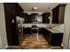 Modern kitchen features stainless steel appliances, granite countertops, dark cabinets and white subway tile backsplash at 201 Lexington Park Dr, Oxford, NC 27565
