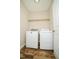 Laundry room with side by side washer and dryer, shelving, and faux wood floor at 201 Lexington Park Dr, Oxford, NC 27565