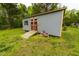 Outdoor shed with double doors and a ramp in a green grassy backyard at 201 Lexington Park Dr, Oxford, NC 27565