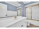 Bright bathroom with a white vanity, large mirror, and gold-trimmed shower at 201 Wendy Pl, Benson, NC 27504