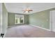 Spacious bedroom with neutral carpet, a ceiling fan, and a window overlooking the yard at 201 Wendy Pl, Benson, NC 27504