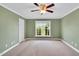 Comfortable bedroom featuring a ceiling fan and a large window with backyard views at 201 Wendy Pl, Benson, NC 27504