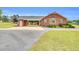 Charming brick home with a carport, blue shutters, and well-maintained landscaping at 201 Wendy Pl, Benson, NC 27504
