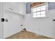 Functional laundry room with tile flooring, overhead cabinets, and natural light at 201 Wendy Pl, Benson, NC 27504