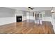 Spacious living room with hardwood floors, a cozy fireplace, and classic white wall paneling at 201 Wendy Pl, Benson, NC 27504