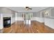 Bright, open living room with hardwood floors, a decorative fireplace, and elegant wall paneling at 201 Wendy Pl, Benson, NC 27504