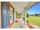 Inviting covered porch with brick accents, white columns, and a view of the lush green lawn at 201 Wendy Pl, Benson, NC 27504