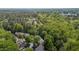 Wide aerial shot presents a community surrounded by lush trees and natural beauty at 206 Black Bird Ct, Cary, NC 27511