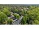 High-angle shot reveals a community nestled within a densely wooded area, showcasing the natural setting at 206 Black Bird Ct, Cary, NC 27511