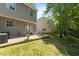 A backyard with a stone patio, outdoor seating, and a view of the green lawn at 206 Black Bird Ct, Cary, NC 27511