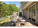 A backyard with a stone patio, outdoor seating, and a green, well-maintained lawn at 206 Black Bird Ct, Cary, NC 27511