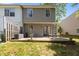 A backyard with a stone patio, outdoor seating, and a view of the green lawn at 206 Black Bird Ct, Cary, NC 27511