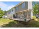 A backyard with a stone patio, outdoor seating, and a view of the green lawn at 206 Black Bird Ct, Cary, NC 27511