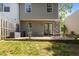 A backyard with a stone patio, outdoor seating, and a view of the green lawn at 206 Black Bird Ct, Cary, NC 27511