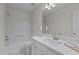 Modern bathroom features white vanity, a large mirror, and a shower-tub combination at 206 Black Bird Ct, Cary, NC 27511