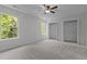 Sunlit bedroom with neutral walls, soft carpet, ceiling fan and two large closets at 206 Black Bird Ct, Cary, NC 27511