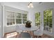 Bright dining area features a marble-look table, white chairs, and a large window with a view to the backyard at 206 Black Bird Ct, Cary, NC 27511
