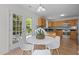 Bright dining area and kitchen features a marble-look table, wood cabinets and stainless appliances at 206 Black Bird Ct, Cary, NC 27511