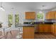 Well-lit kitchen with hardwood floors, a breakfast bar, and stainless steel appliances at 206 Black Bird Ct, Cary, NC 27511