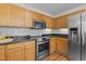 Modern kitchen featuring stainless steel appliances, granite countertops, and wooden cabinetry at 206 Black Bird Ct, Cary, NC 27511