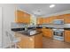 Well-equipped kitchen with granite countertops, stainless steel appliances, and wooden cabinets at 206 Black Bird Ct, Cary, NC 27511